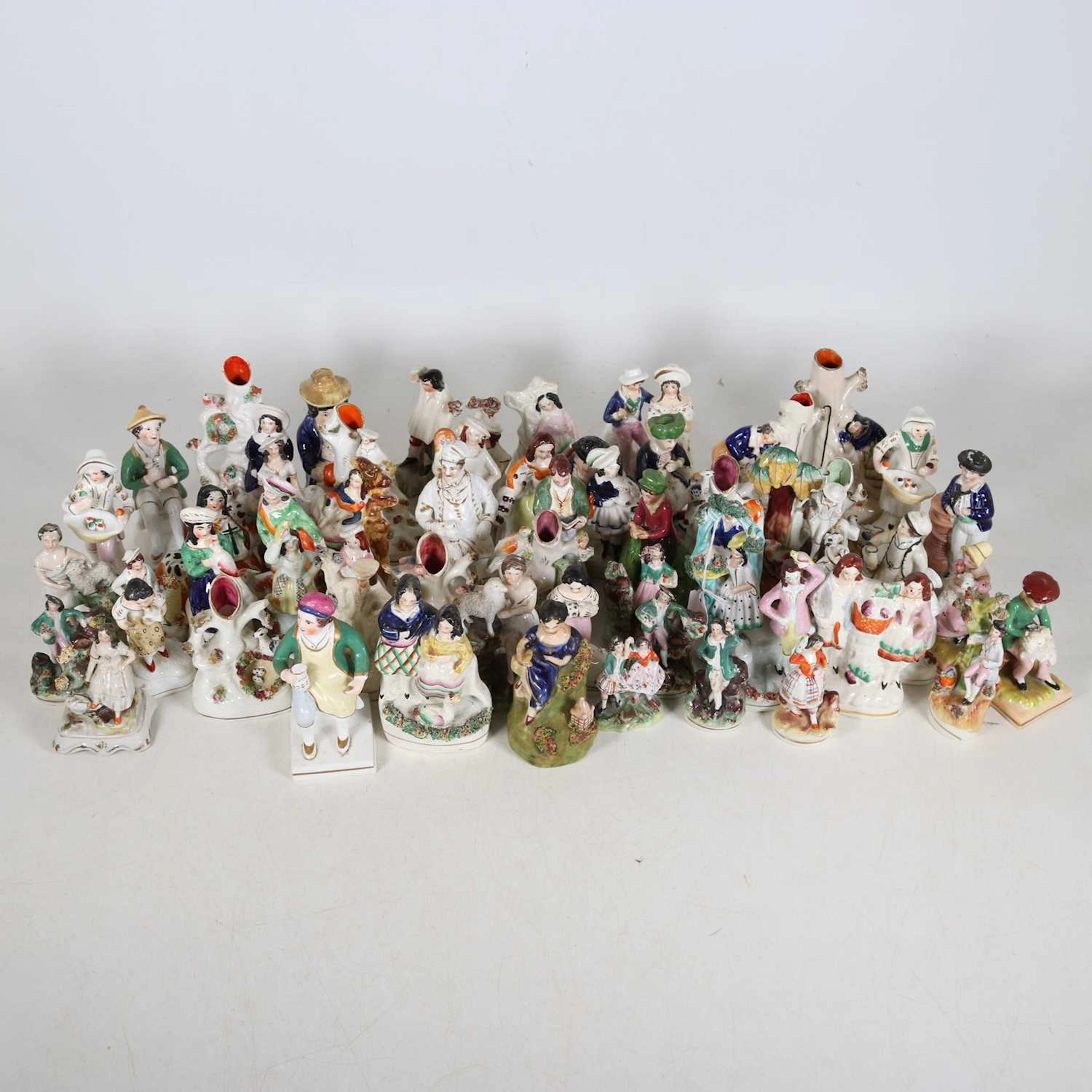 Lot 124 - A collection of Staffordshire figures, to