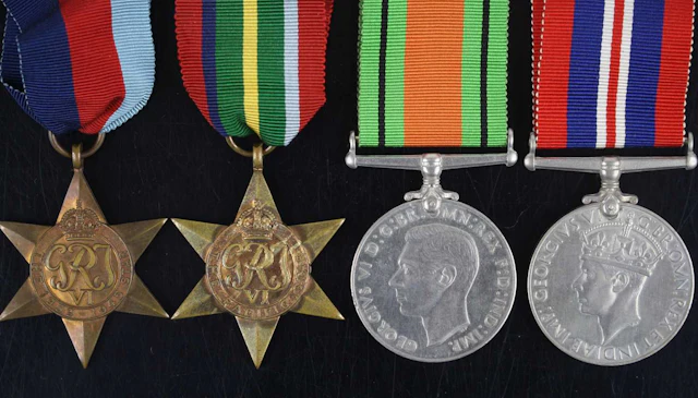 Lot 1038 - A group of four WW II medals to include