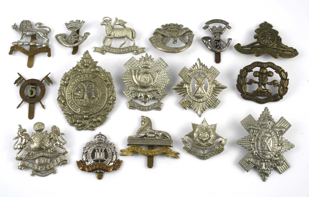Lot 1265 - A collection of cap badges to include