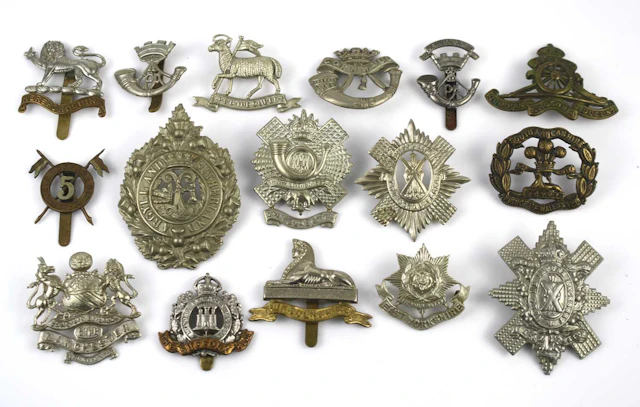 Lot 1265 - A collection of cap badges to include