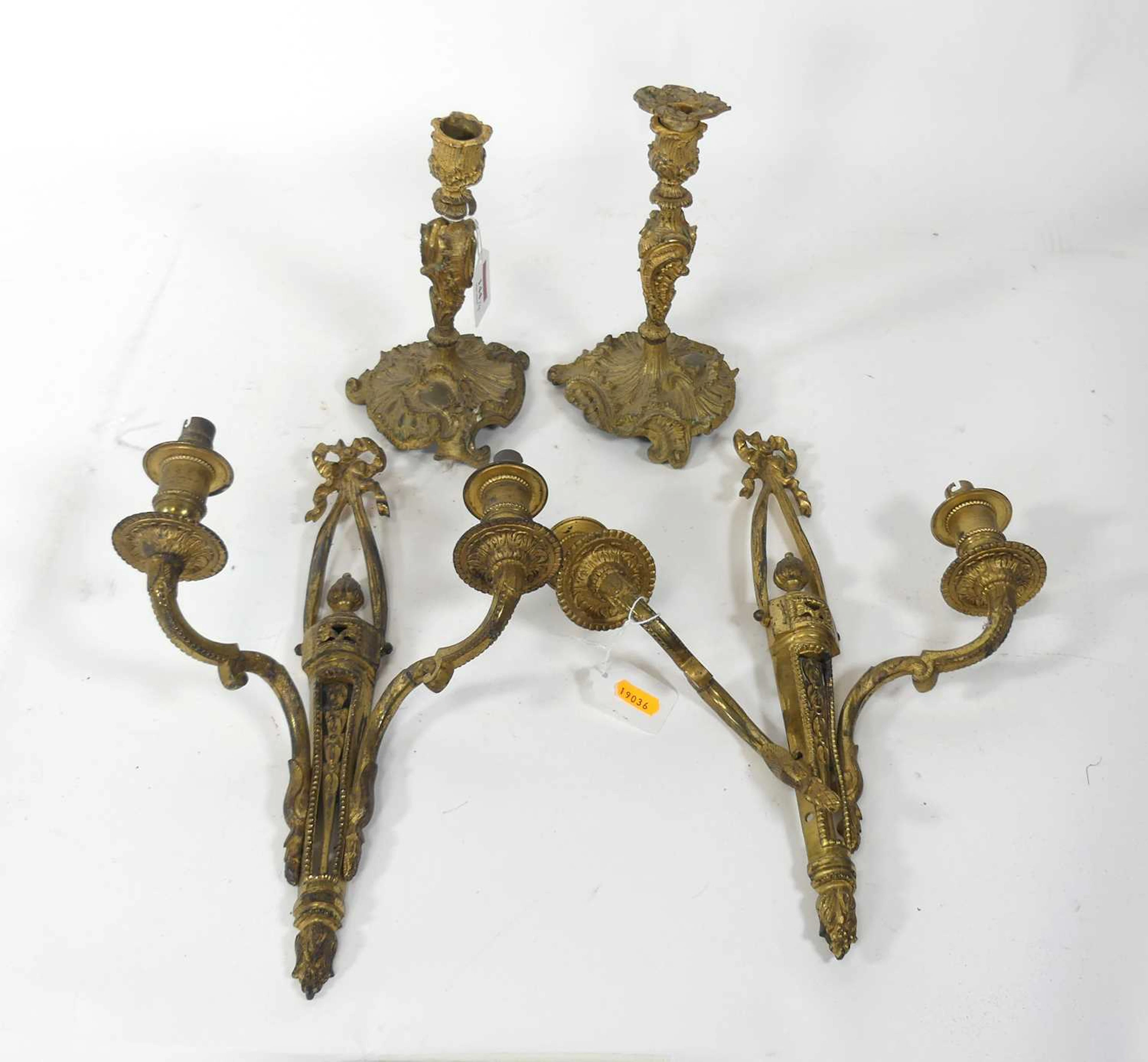 Lot 144 - A pair of gilt brass table candlesticks, in