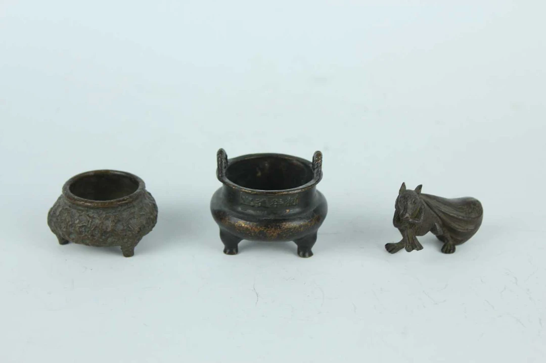 Lot 211 - A group of three Chinese and Japanese bronze