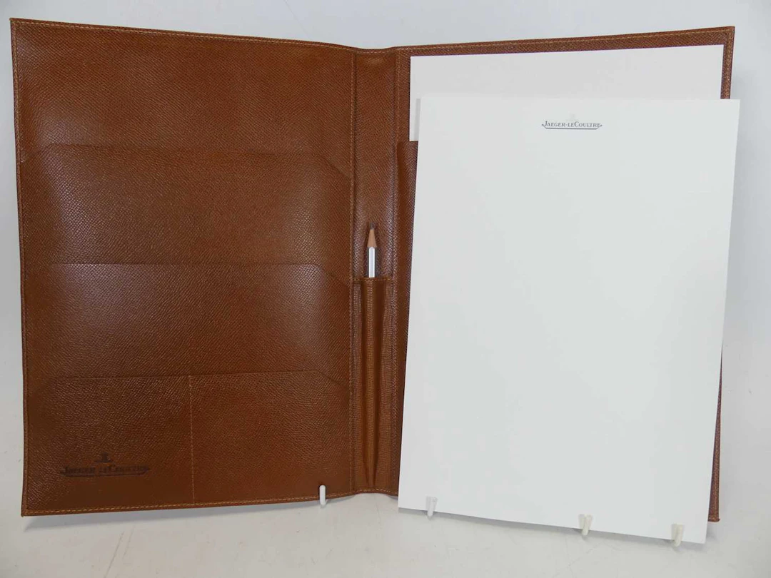 Lot 477 - A Jaeger LeCoultre tan leather notebook