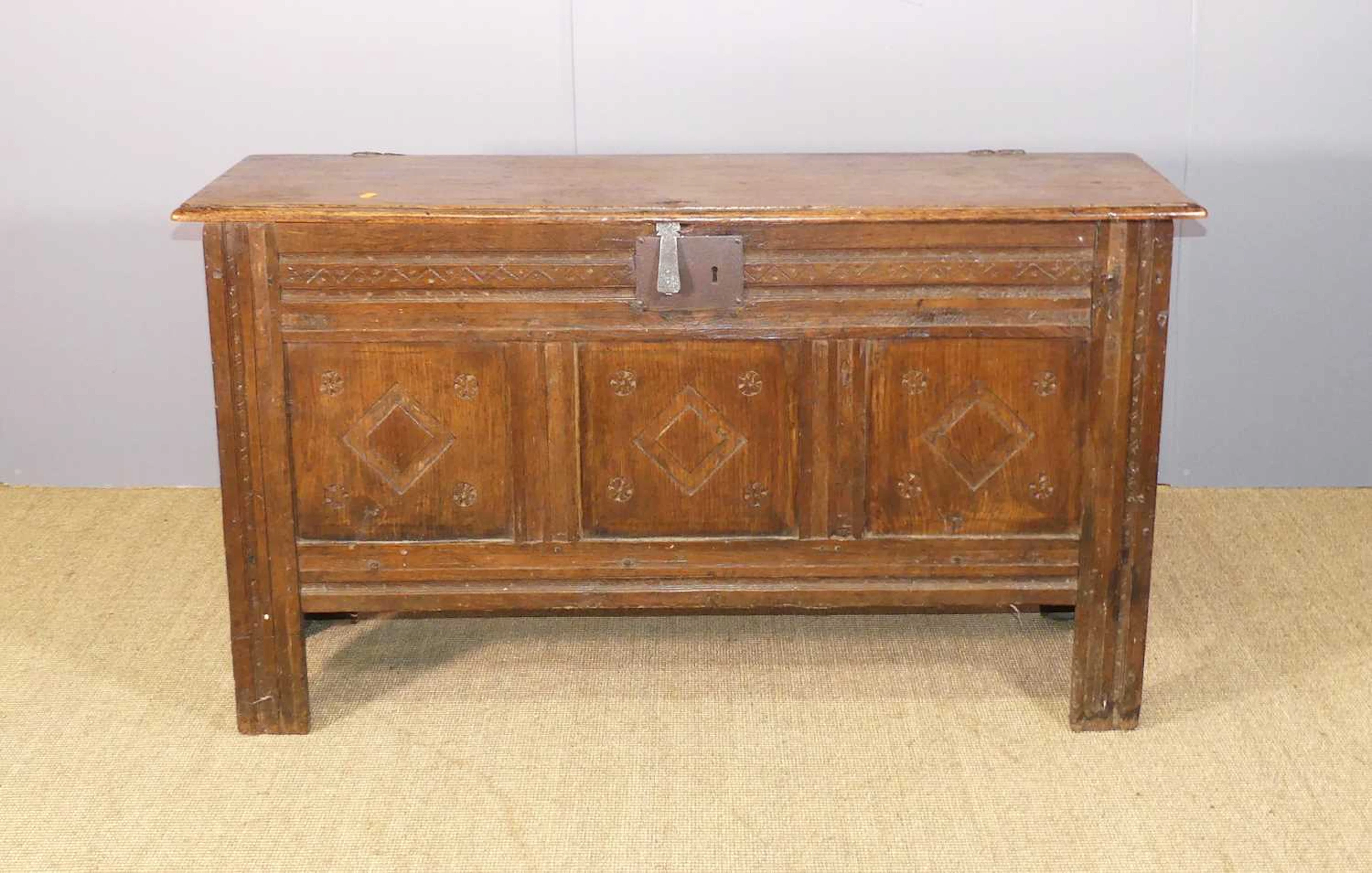 Lot 637 - An antique joined oak hinge-top three-panel