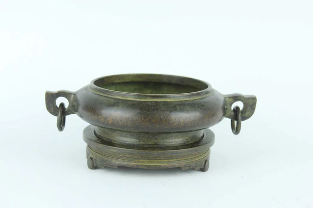 Lot 34 - A Chinese bronze censer with twin ring