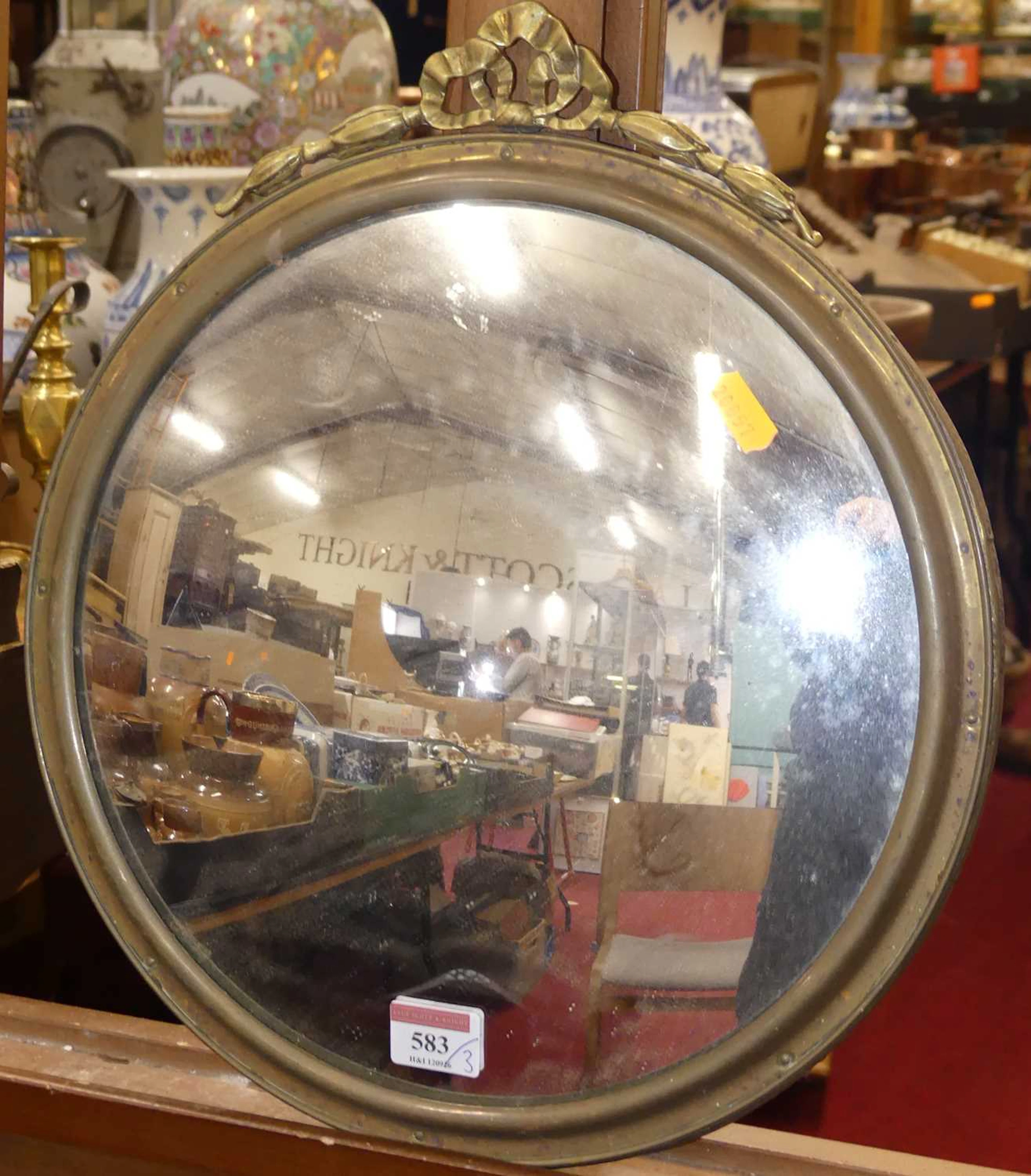 Lot 583 - A gilt metal framed convex wall mirror, a
