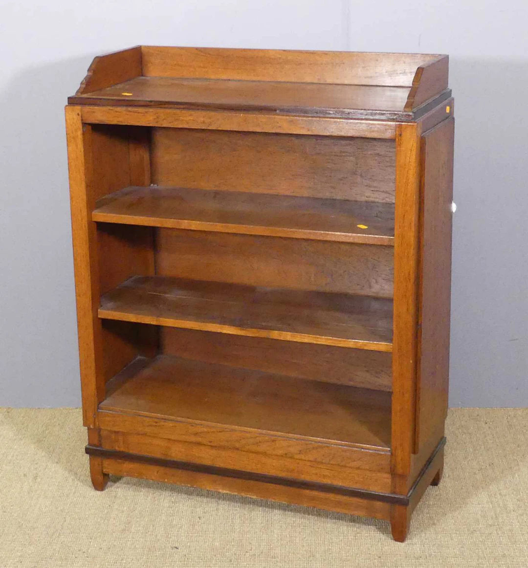 Lot 702 - An Art Deco oak low ledgeback bookshelf, of