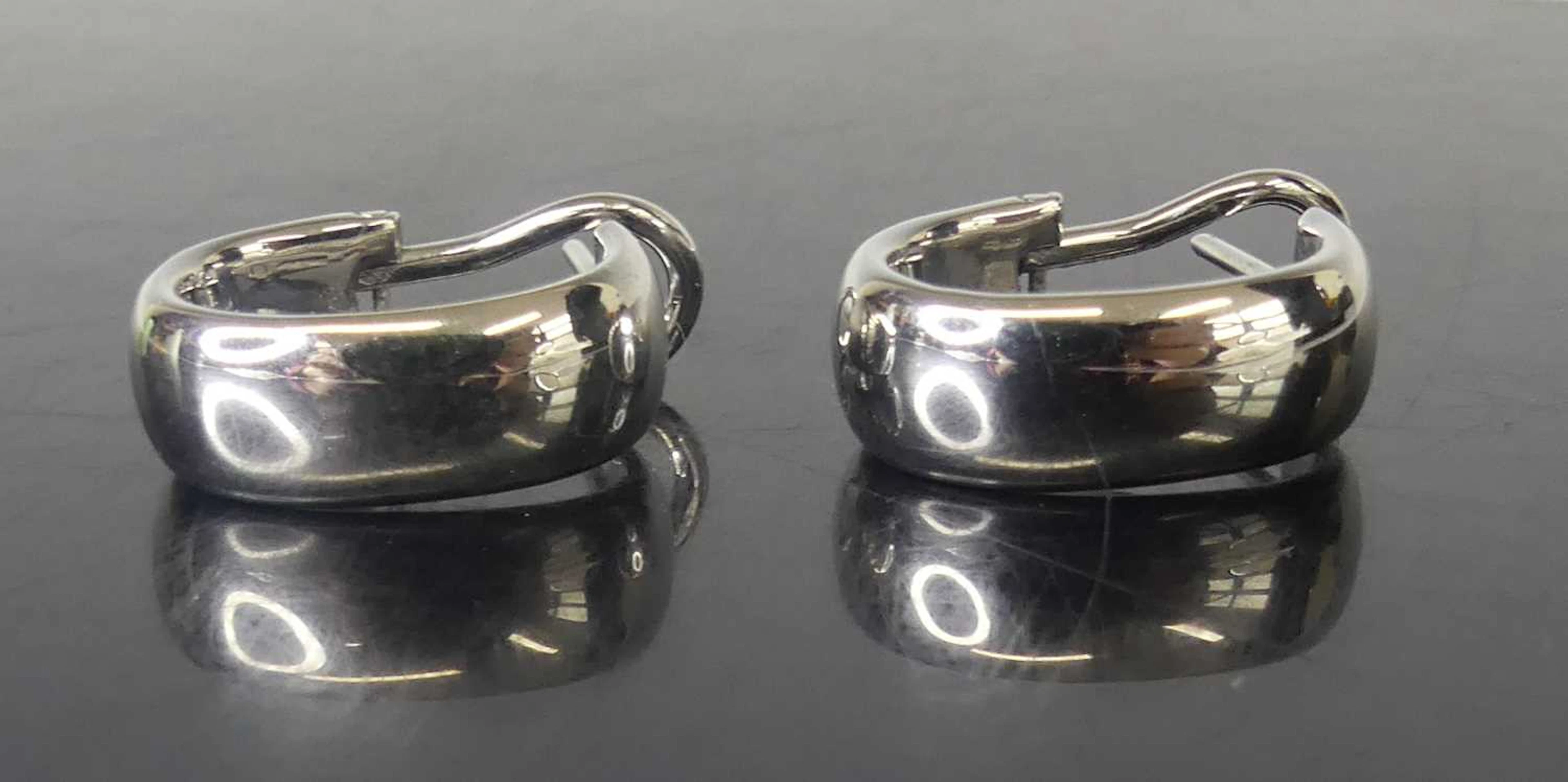 Lot 2553 - A pair of 18ct white gold half-hoop