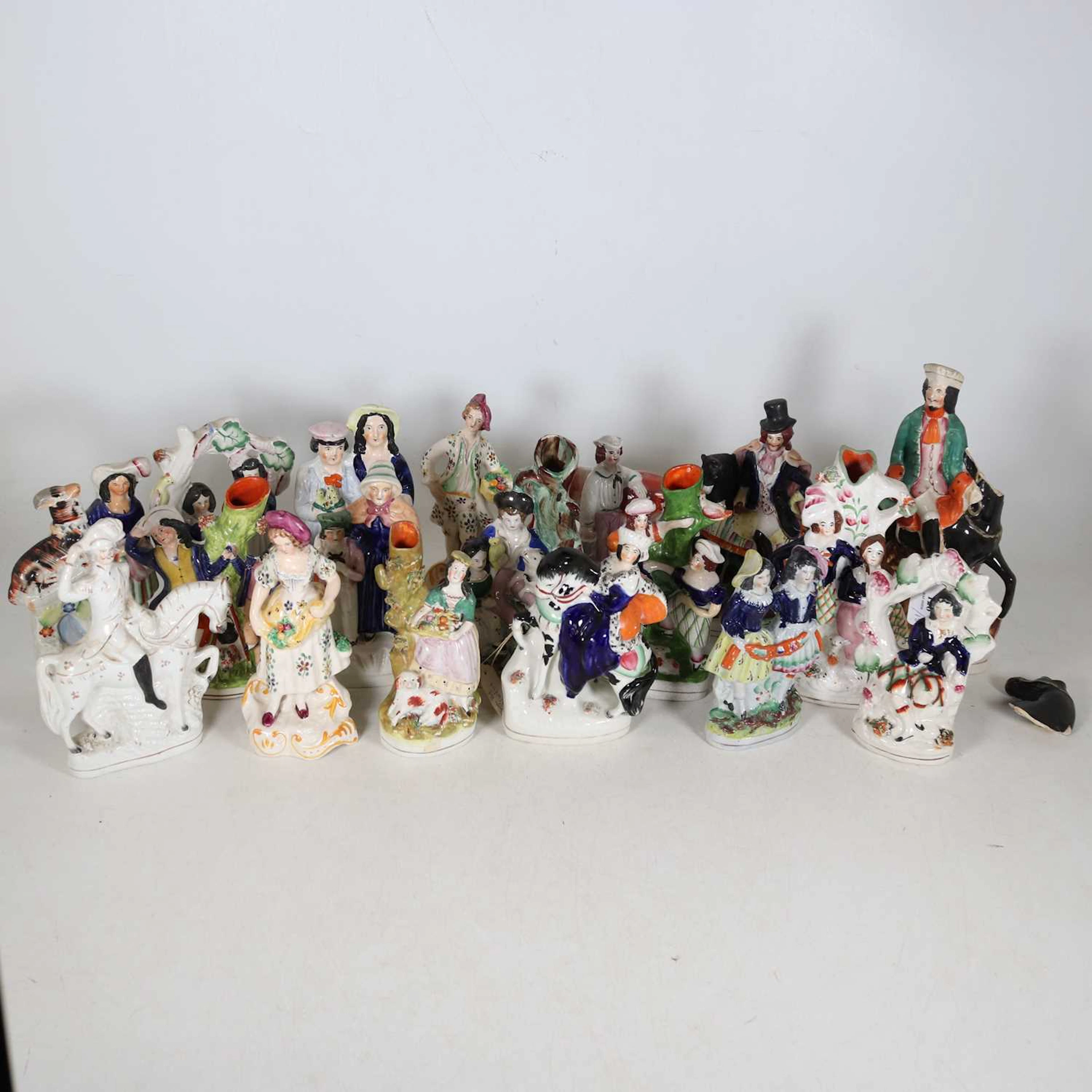 Lot 126 - A collection of Staffordshire figures, to