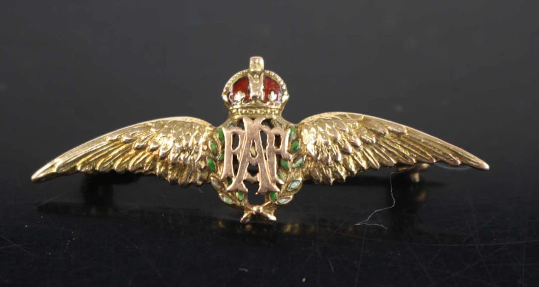 Lot 1069 - A WW II yellow metal and enamelled RAF