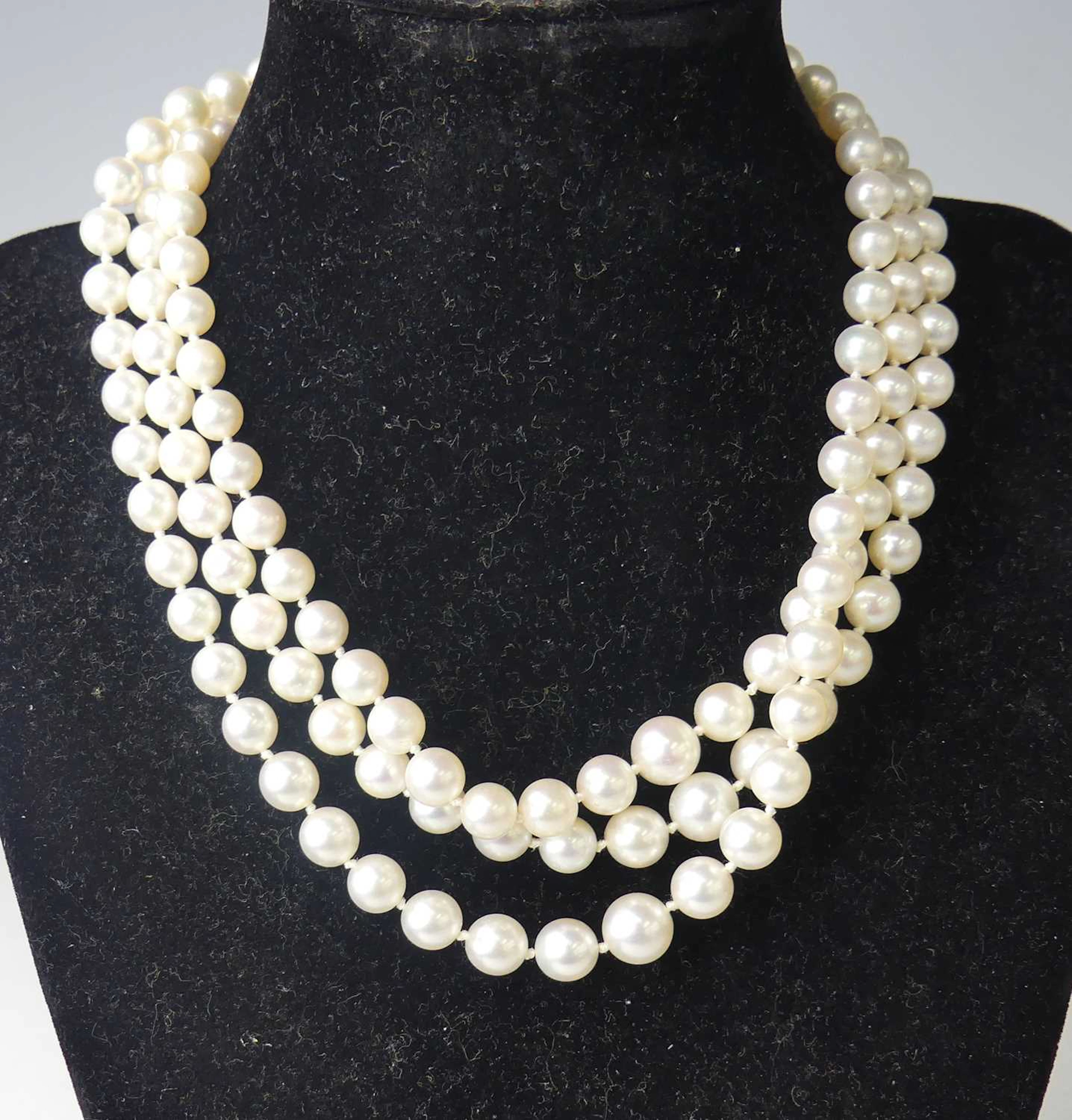 Lot 2514 - A three-row cultured Akoya pearl necklace