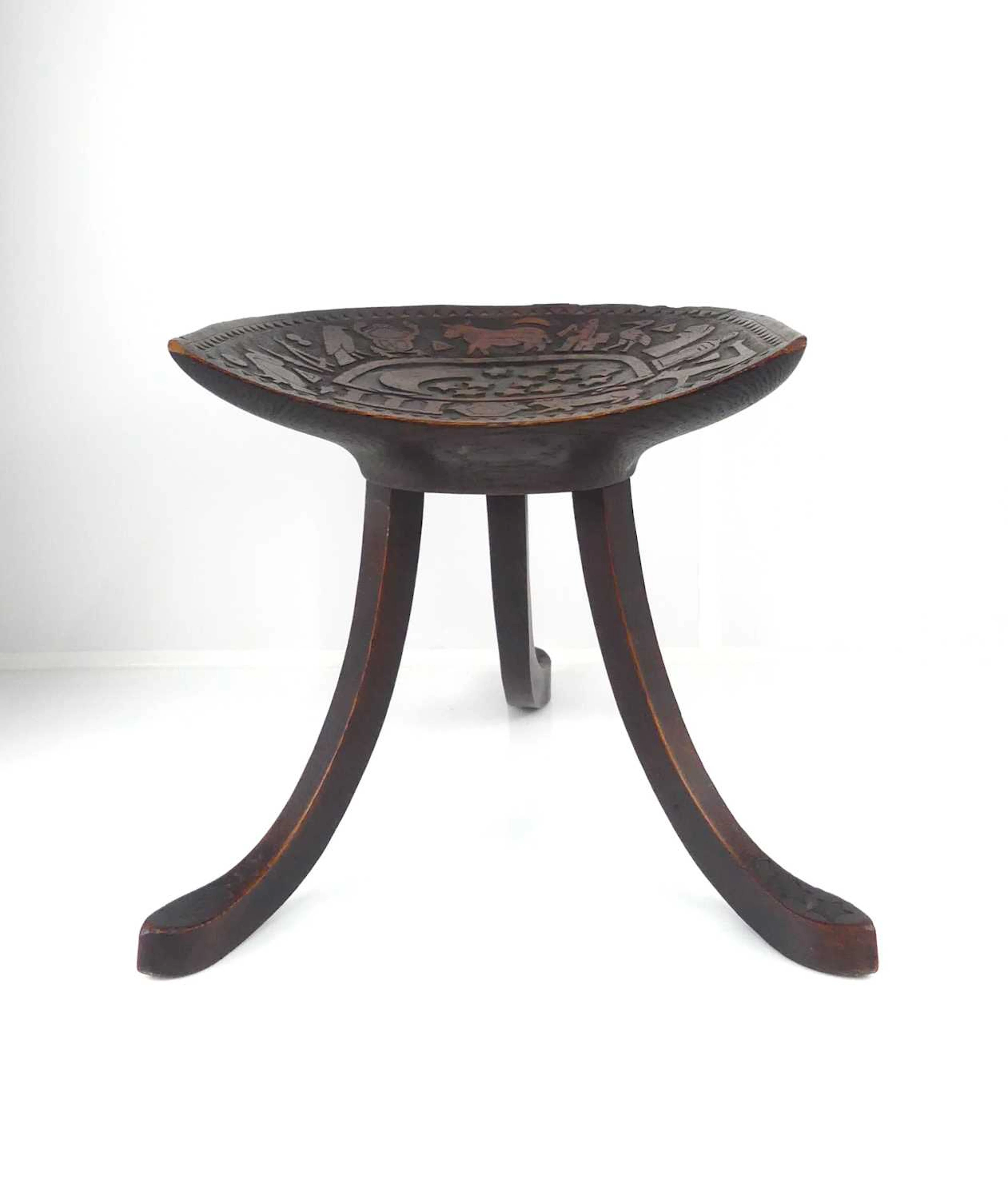 Lot 463 - Liberty & Co - an oak 'Thebes' stool, the