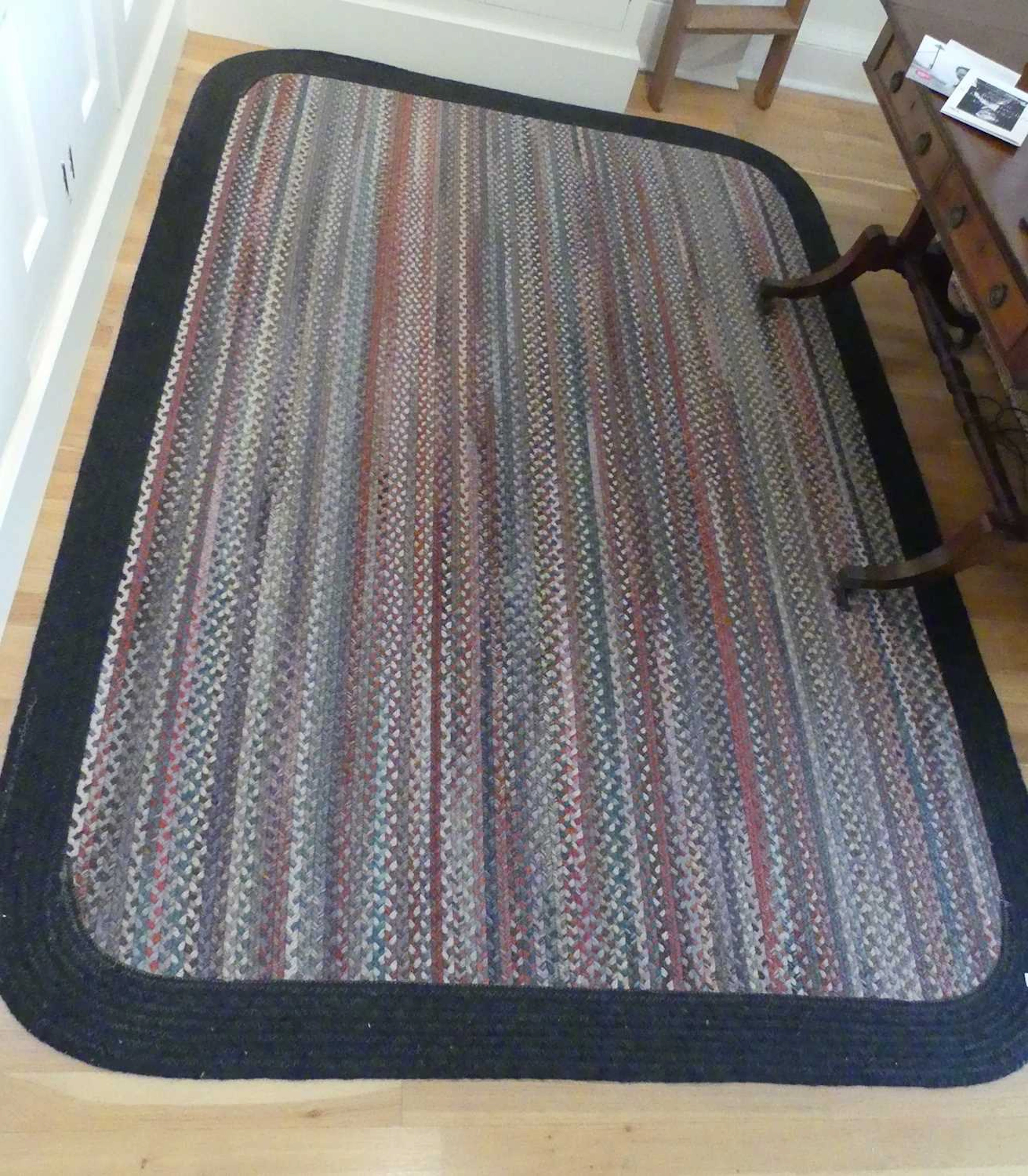Lot 1258 - A braided woollen rug, decorated with long