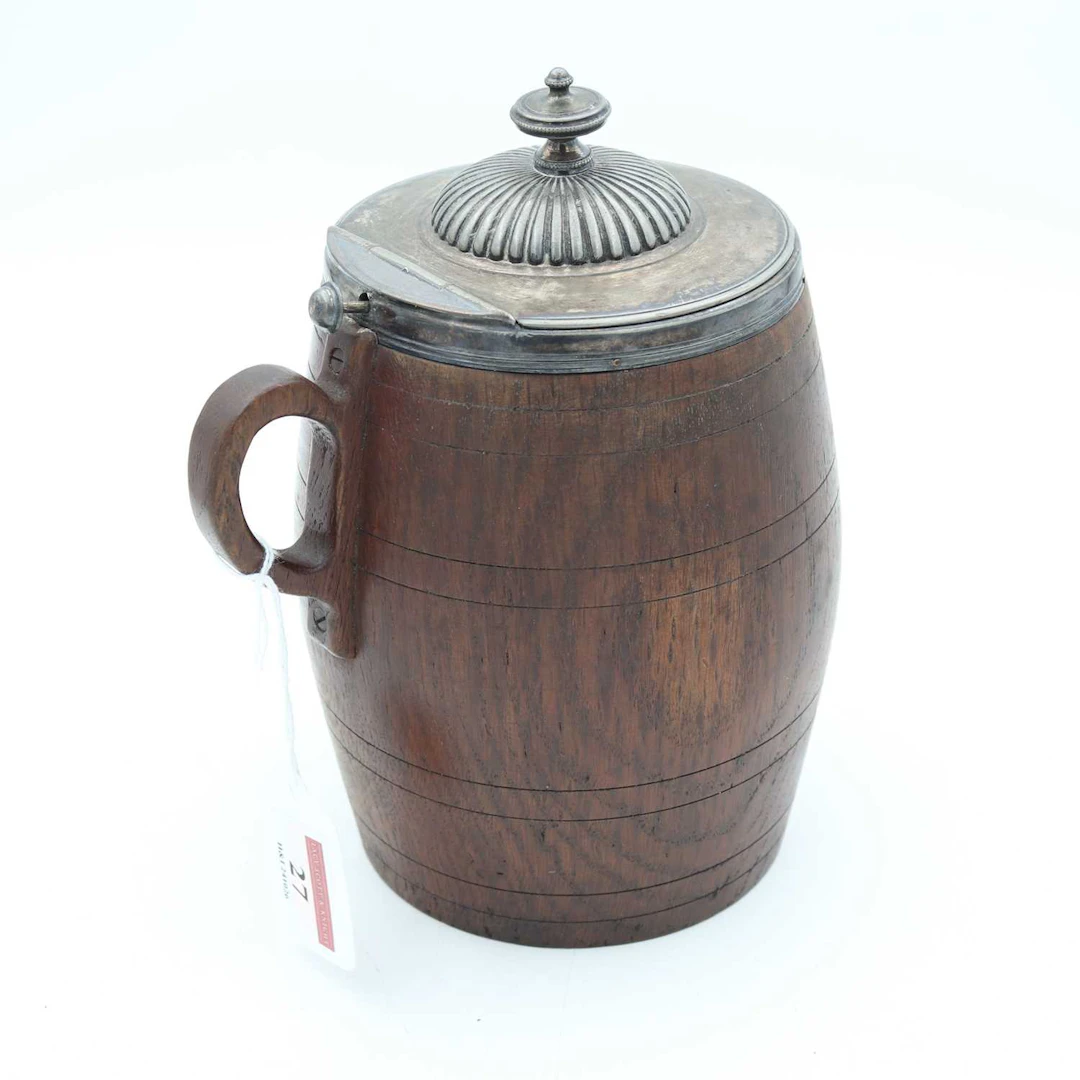 Lot 27 - A late 19th century oak tankard, having a