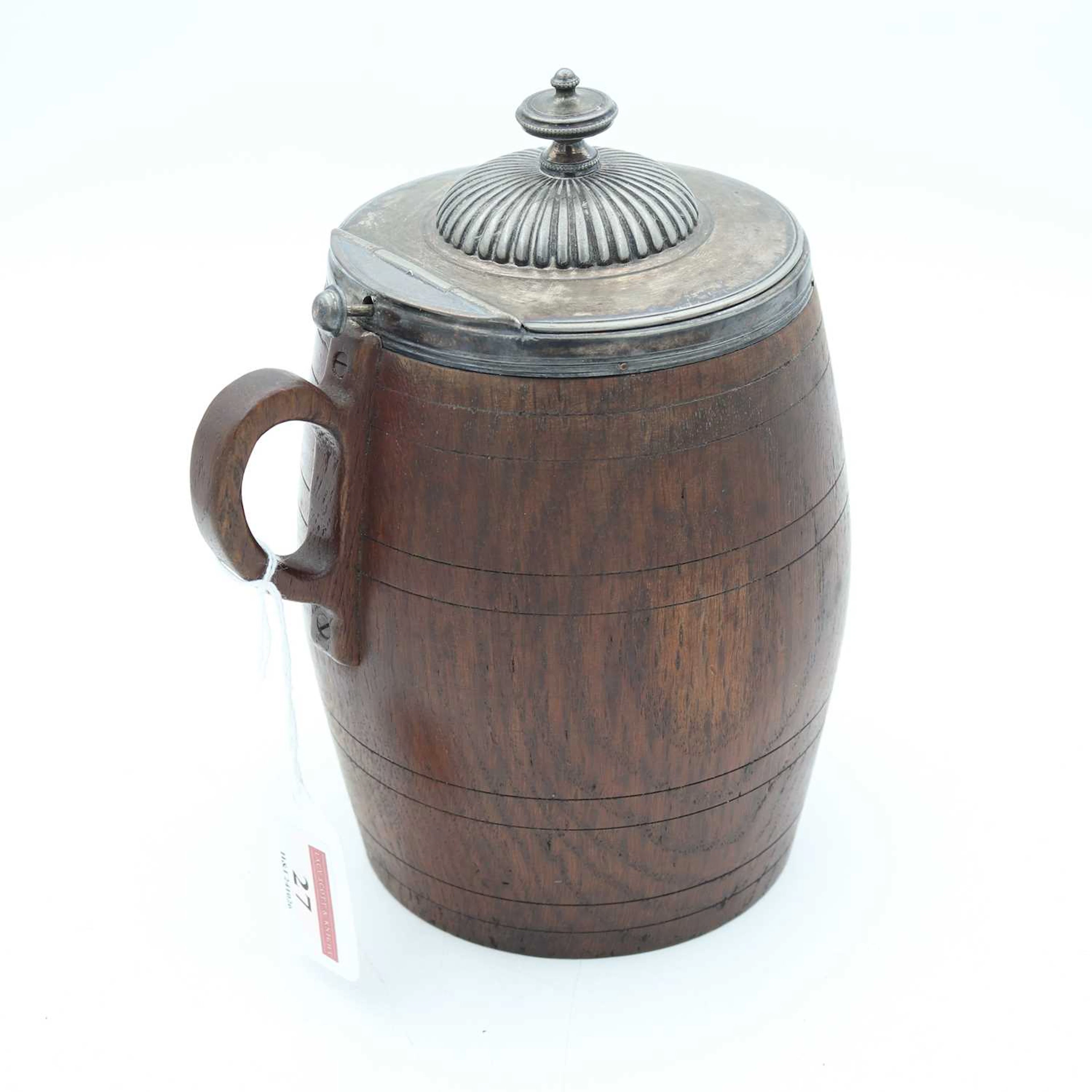 Lot 27 - A late 19th century oak tankard, having a