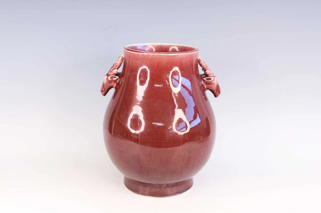 Lot 74 - A Chinese copper-red glazed deer-head handled