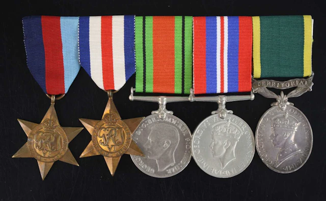 Lot 1271 - A group of five medals to include WW II