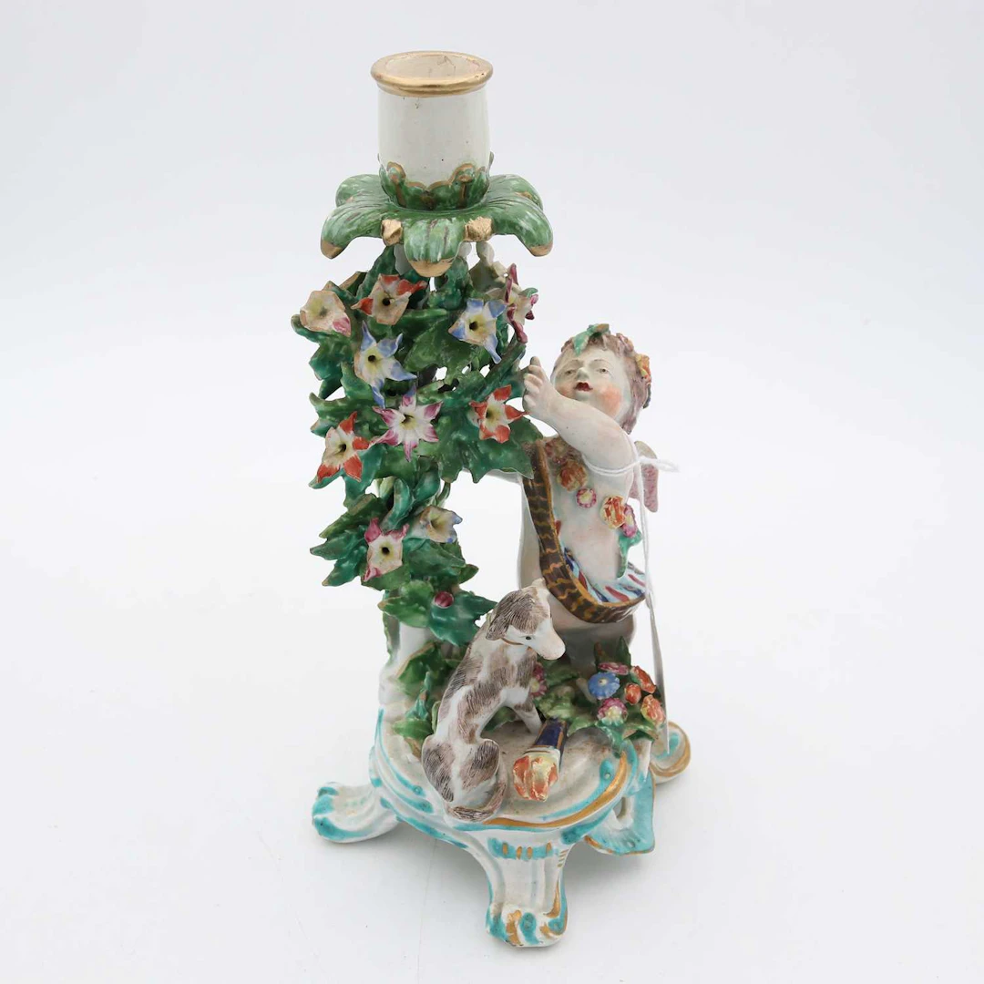 Lot 112 - A Bow porcelain cherub candle-holder, with