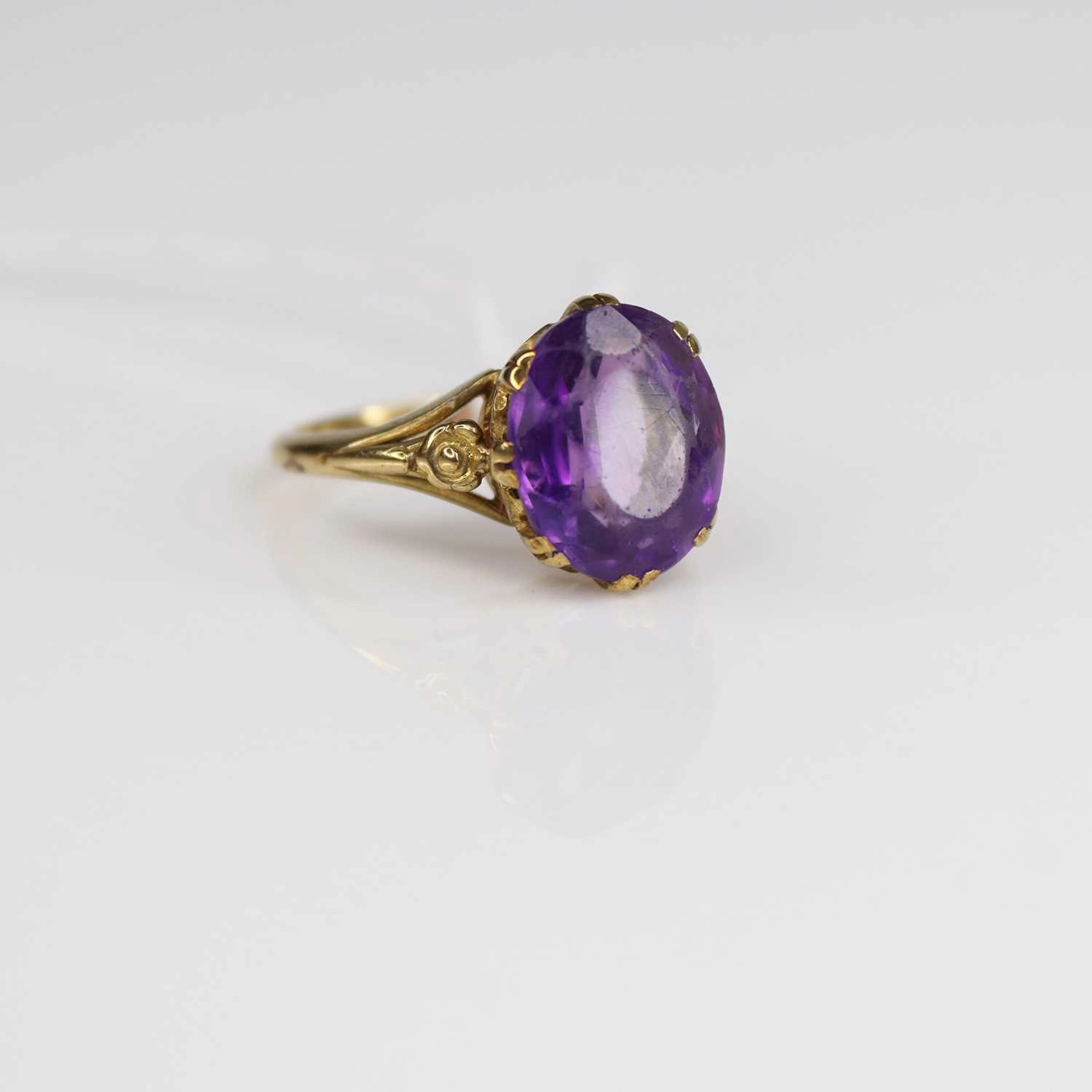 Lot 218 - A 9ct gold and amethyst set dress ring, the