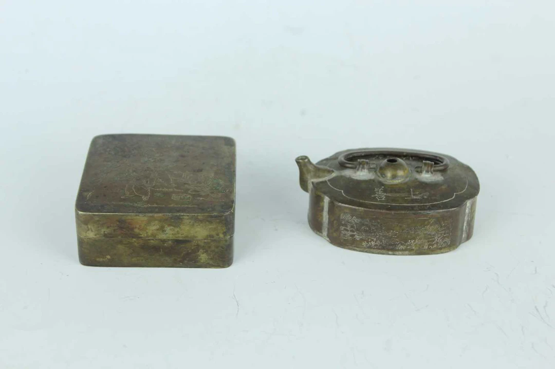 Lot 36 - A Chinese bronze ink box together with a