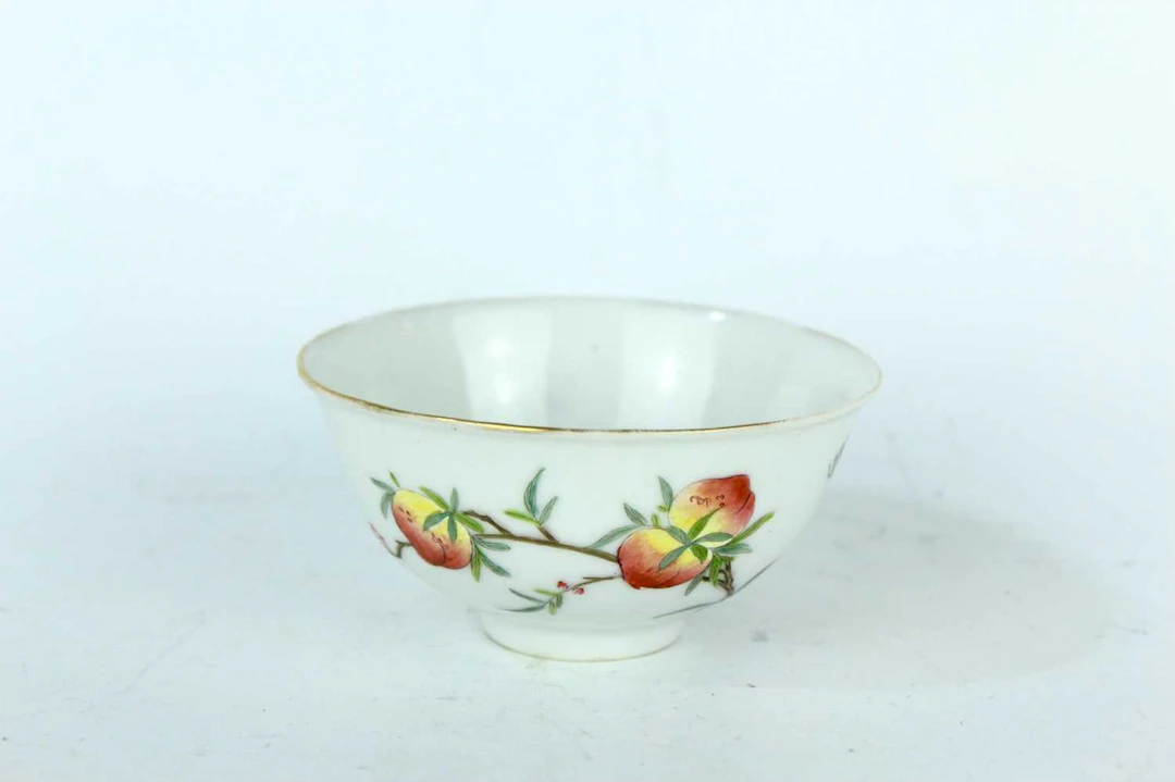 Lot 111 - A small Chinese famille rose ‘peaches and