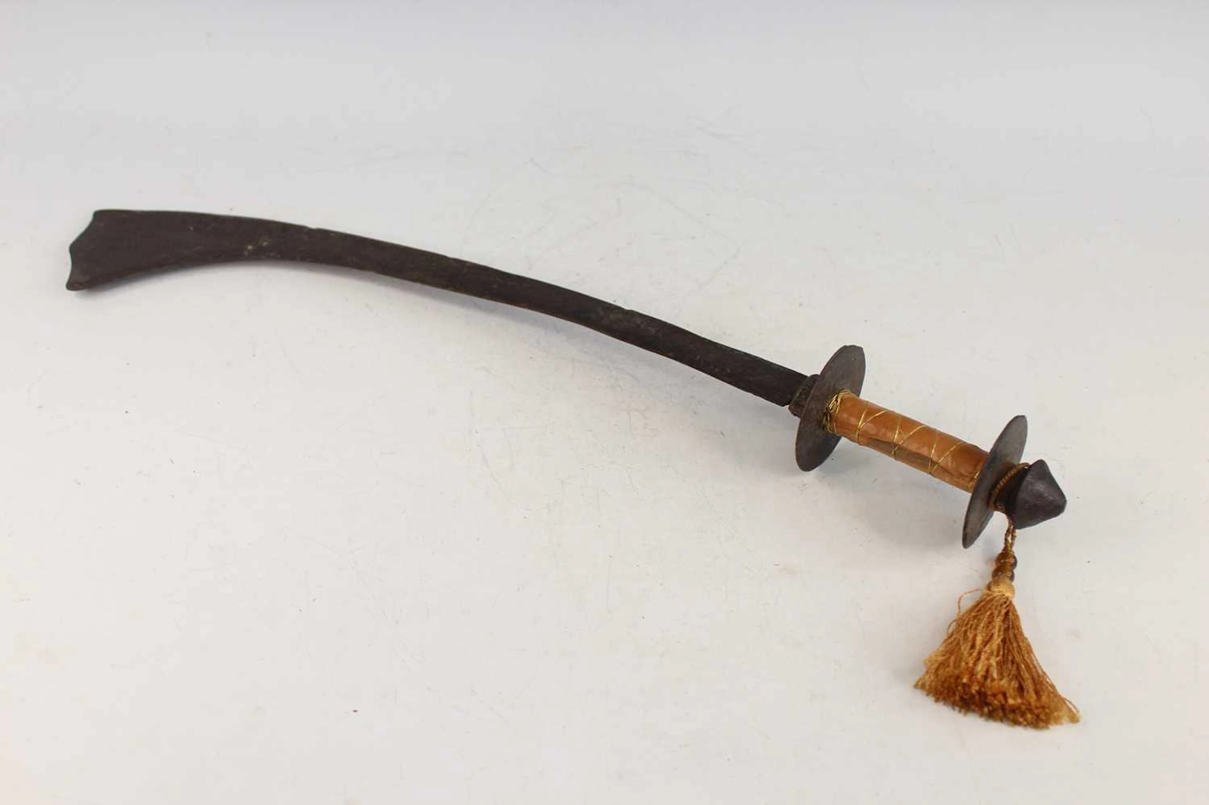 Lot 226 - A Nepalese curved iron sword, probably 19th