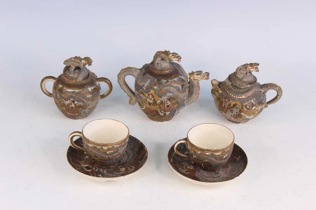 Lot 197 - A Japanese Satsuma pottery 'Dragon' tea set