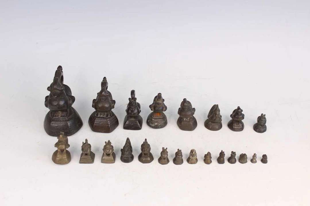 Lot 218 - A group of 22 Burmese bronze animal-form