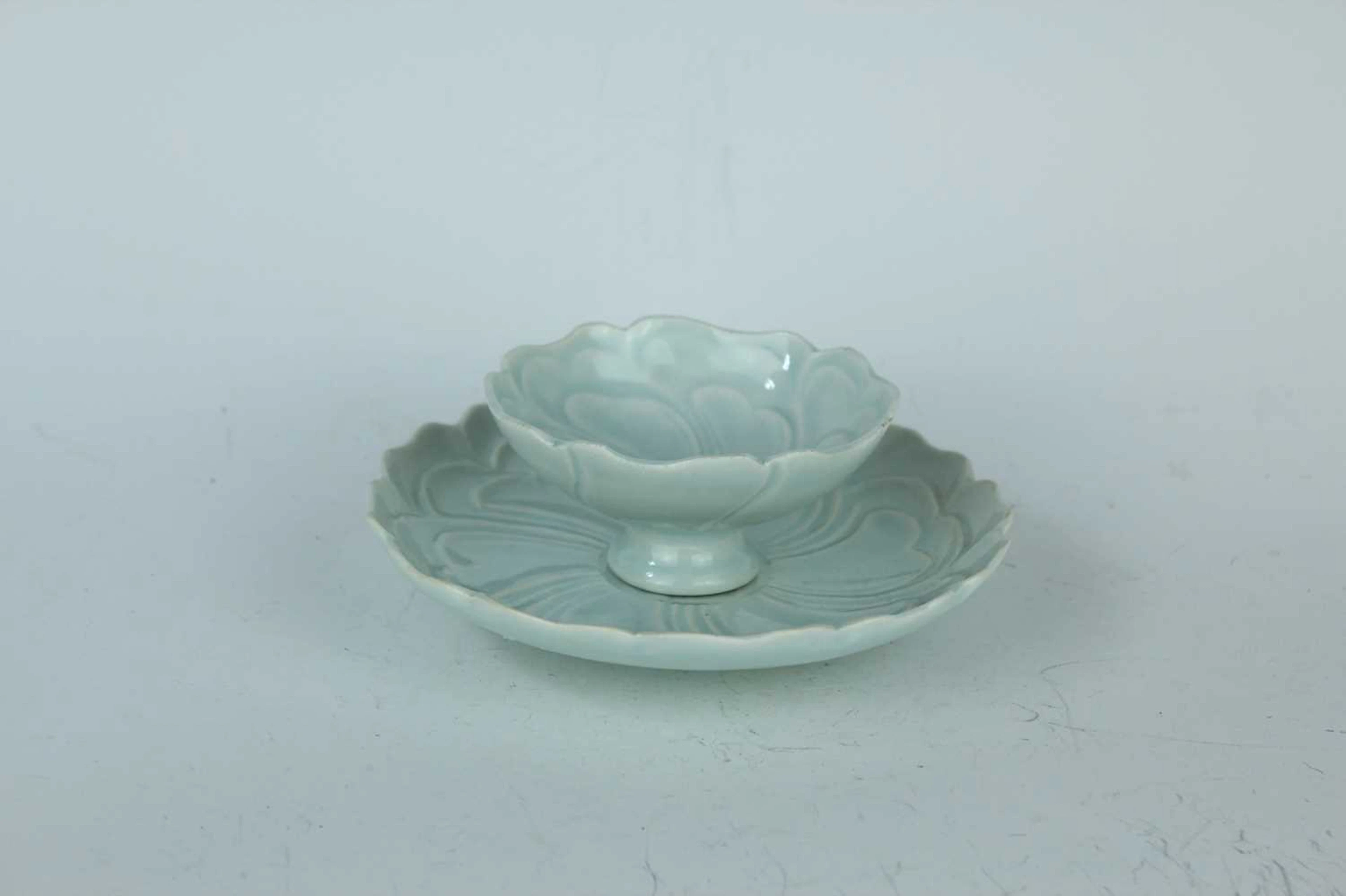 Lot 58 - A Chinese qingbai-glazed cup and saucer, Song