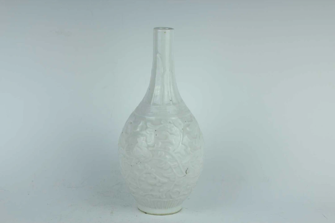 Lot 53 - A Chinese white-glazed mould-decorated bottle