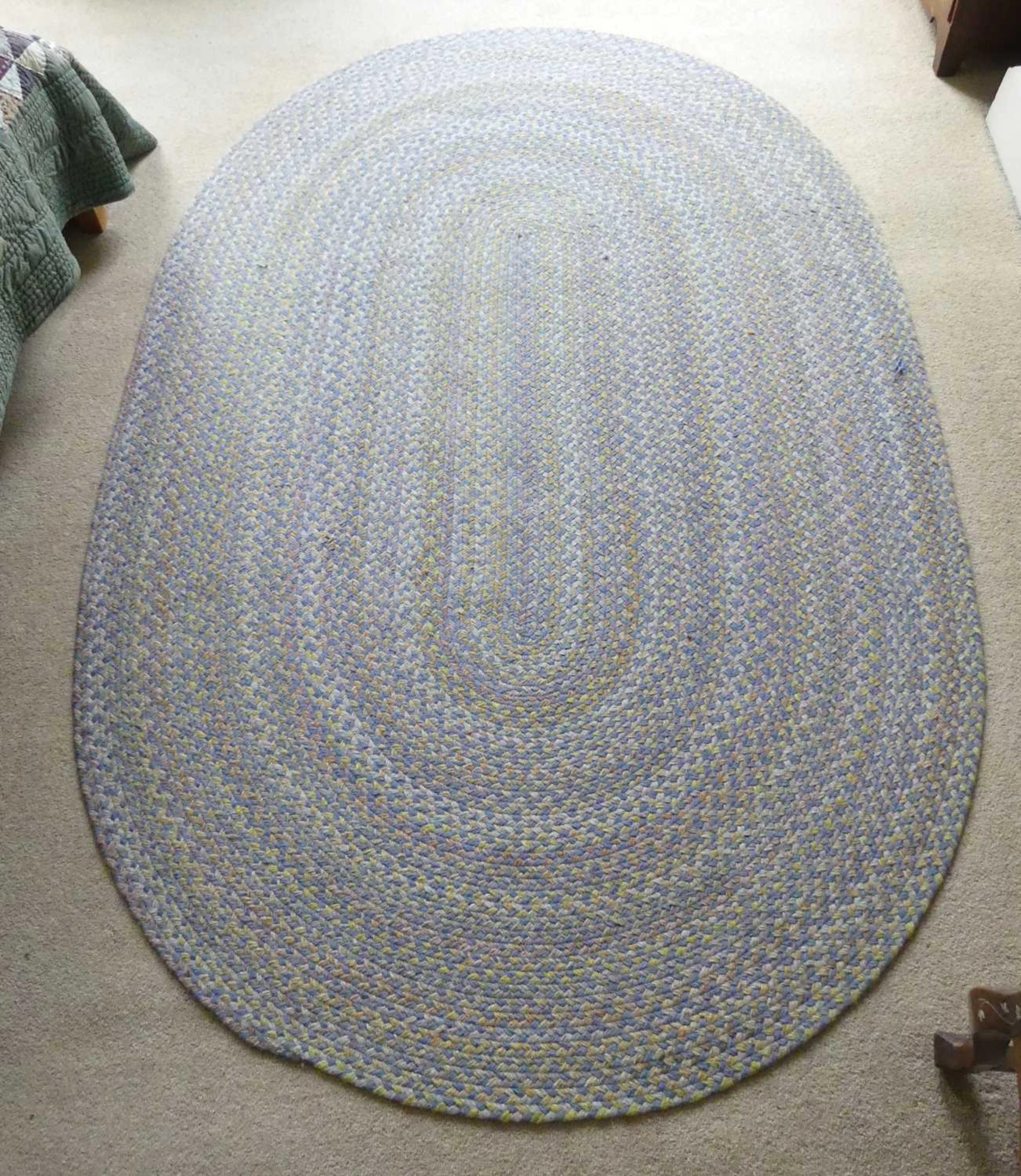 Lot 1256 - A contemporary braided oval rug, as