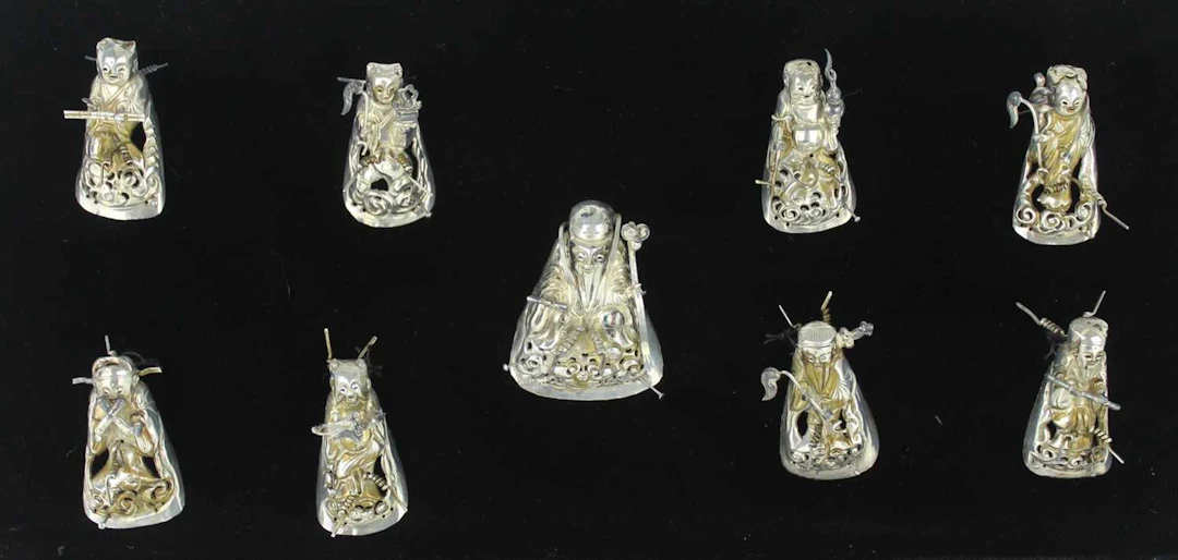 Lot 43 - A set of nine Chinese silver garment ornament