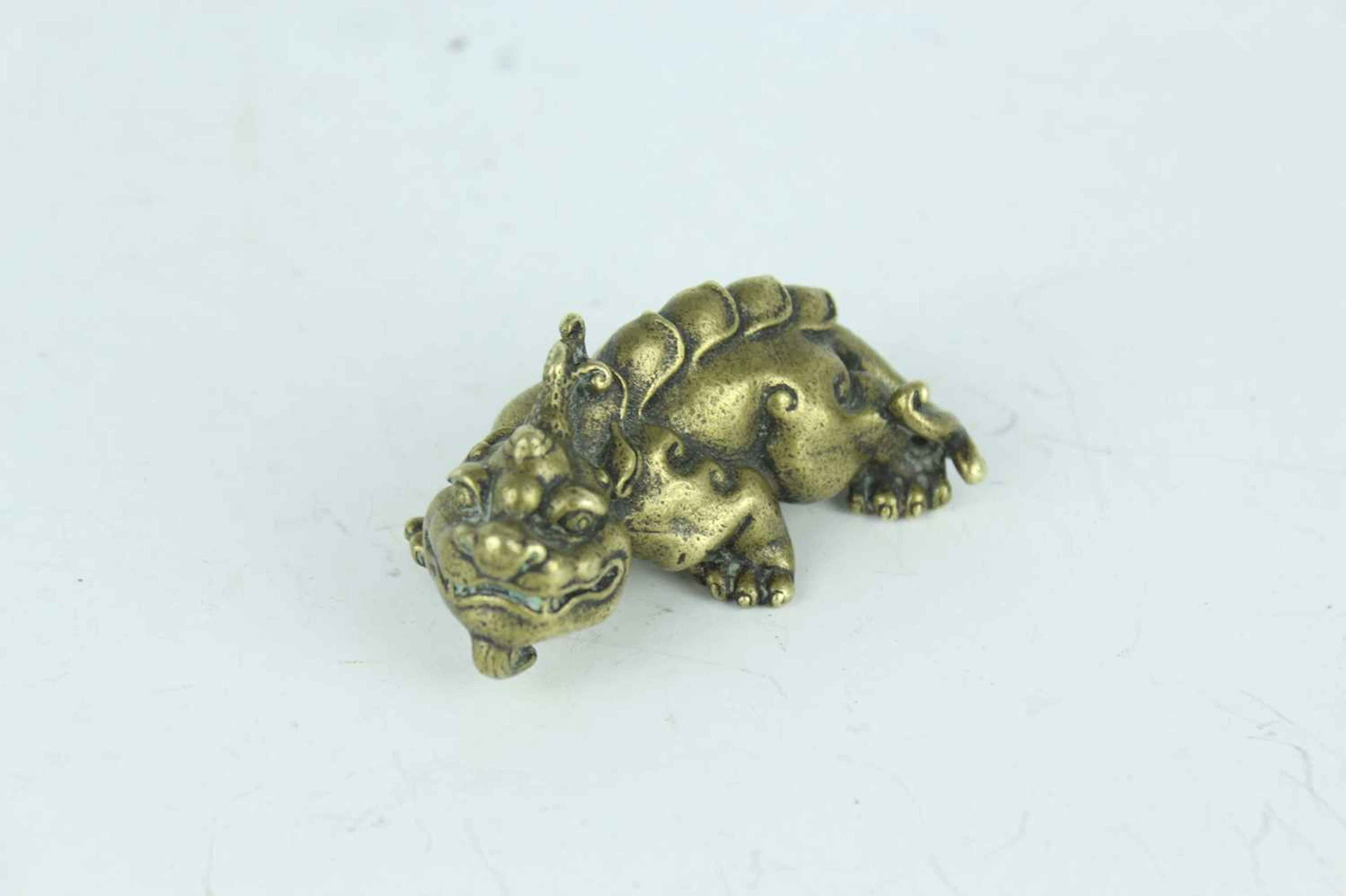 Lot 31 - A Chinese bronze mythical beast paperweight