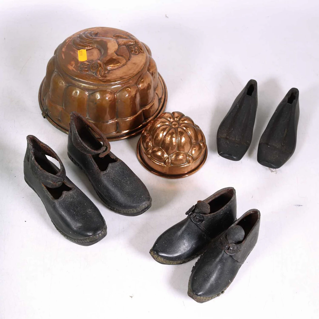 Lot 35 - Two cooper jelly moulds; together with a pair