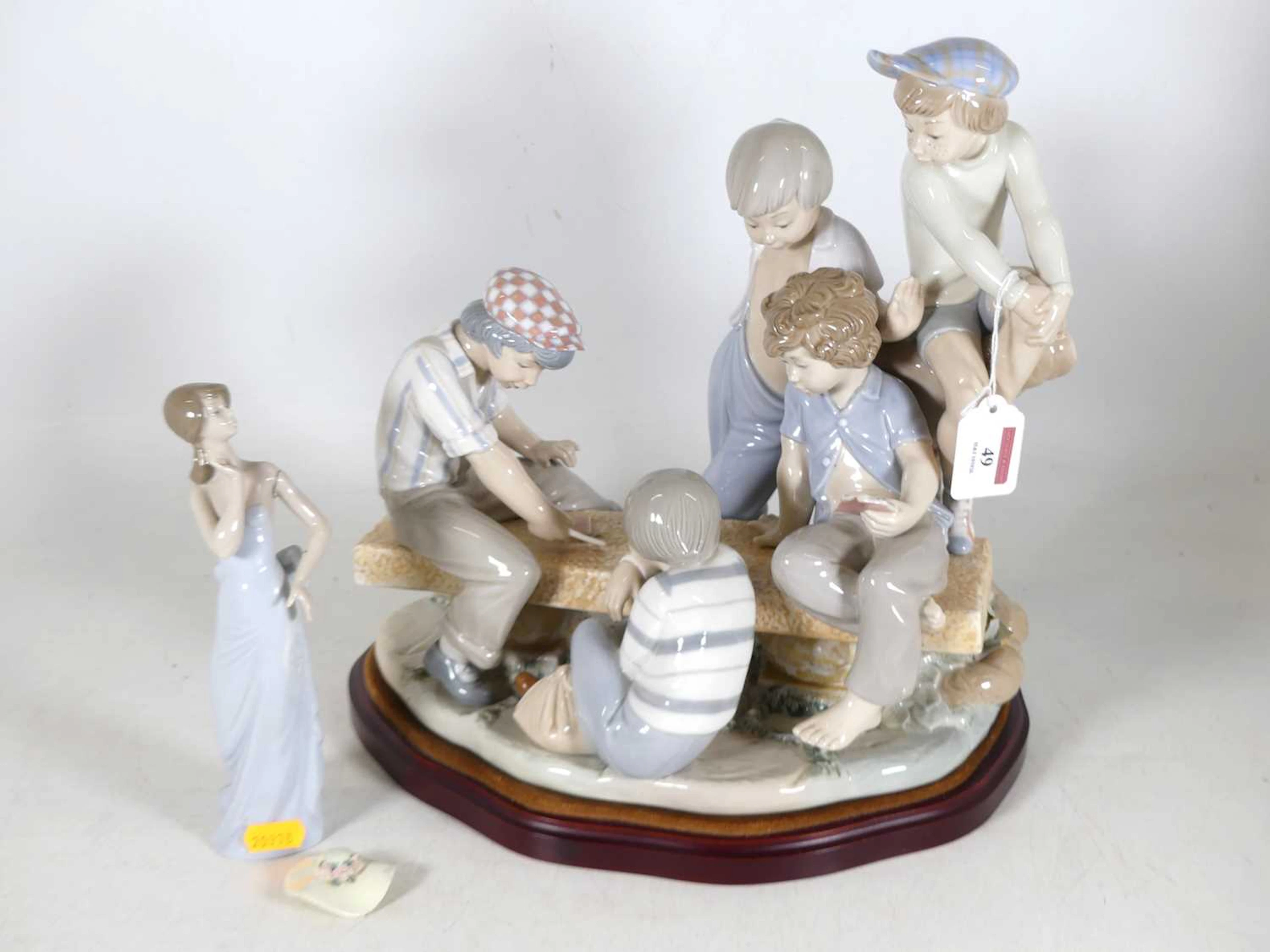 Lot 49 - A Nao porcelain figure group 'Boys playing