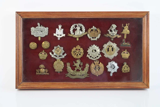 Lot 1163 - A collection of cap badges to include 25th