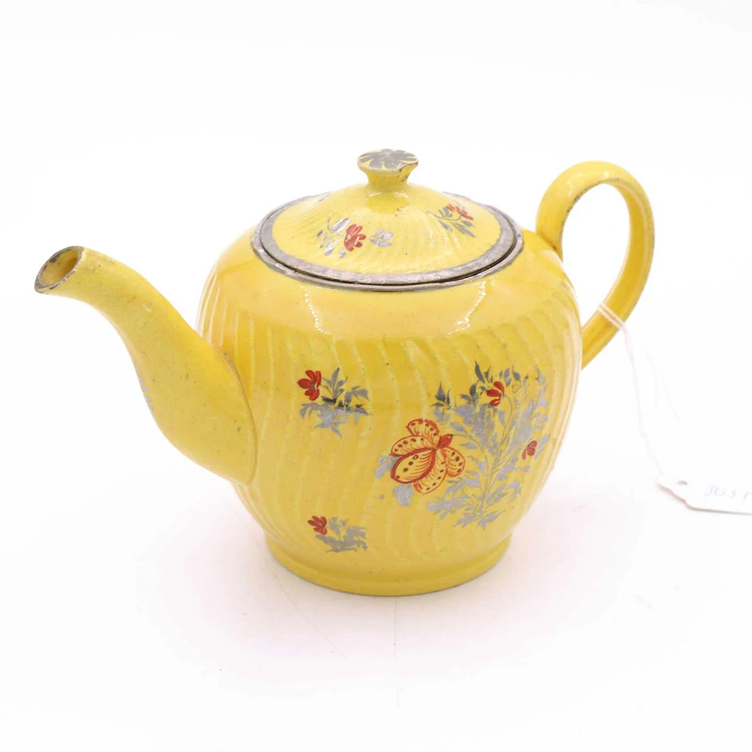 Lot 104 - A Staffordshire yellow ware teapot, circa