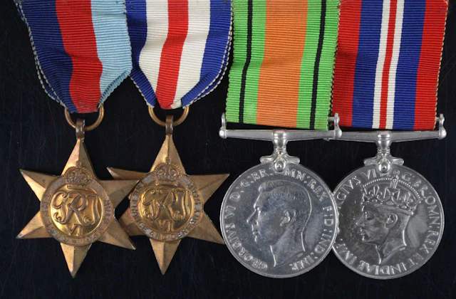 Lot 1125 - A group of four WW II medals to include
