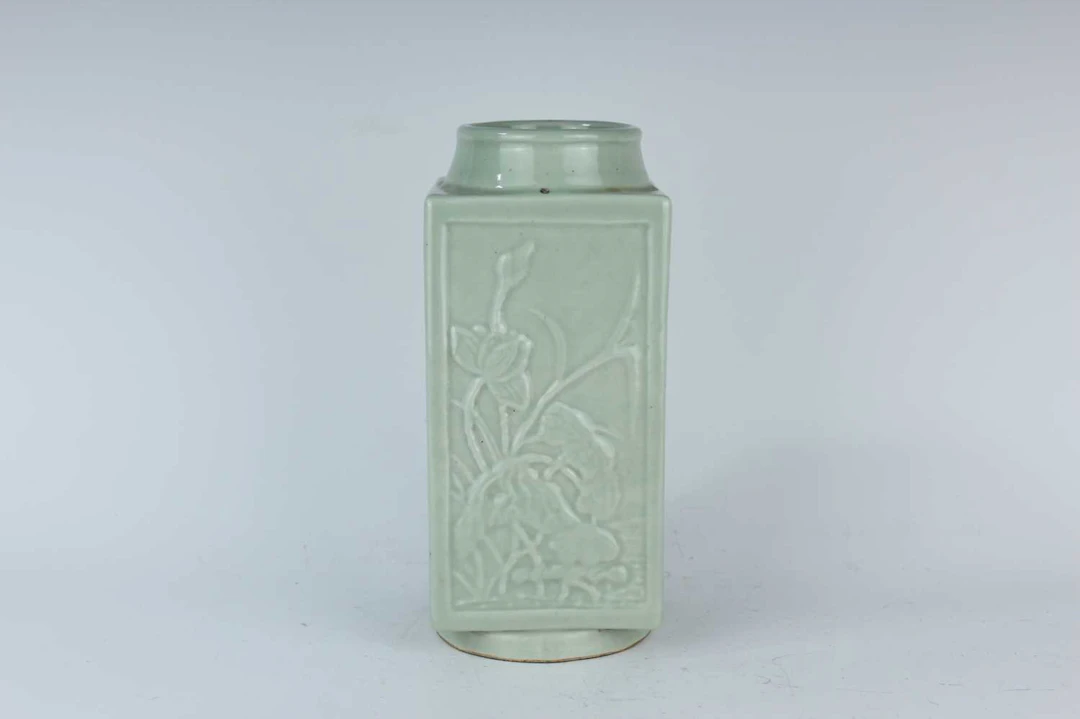 Lot 54 - A Chinese celadon-glazed mould-decorated cong-