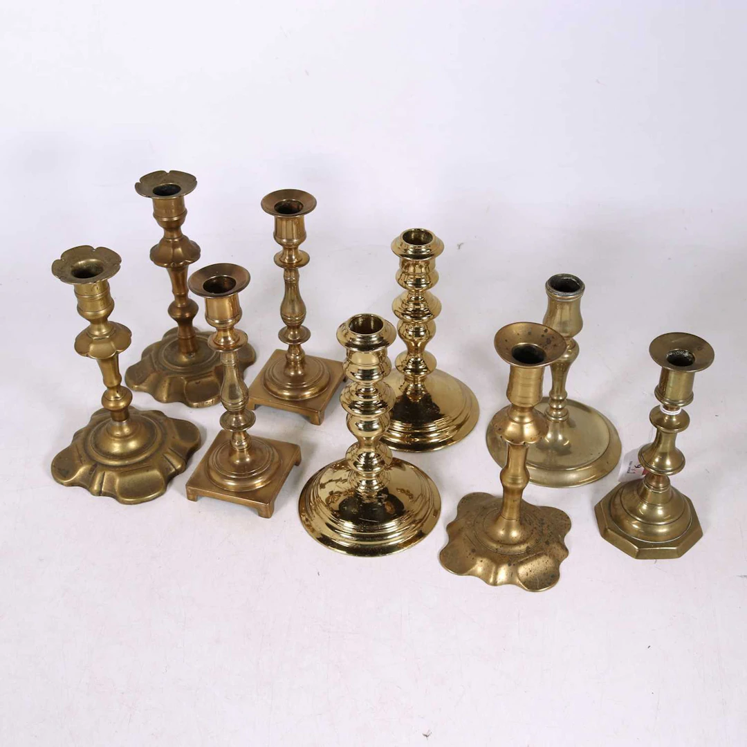 Lot 9 - A collection of brass table candlesticks, 18th