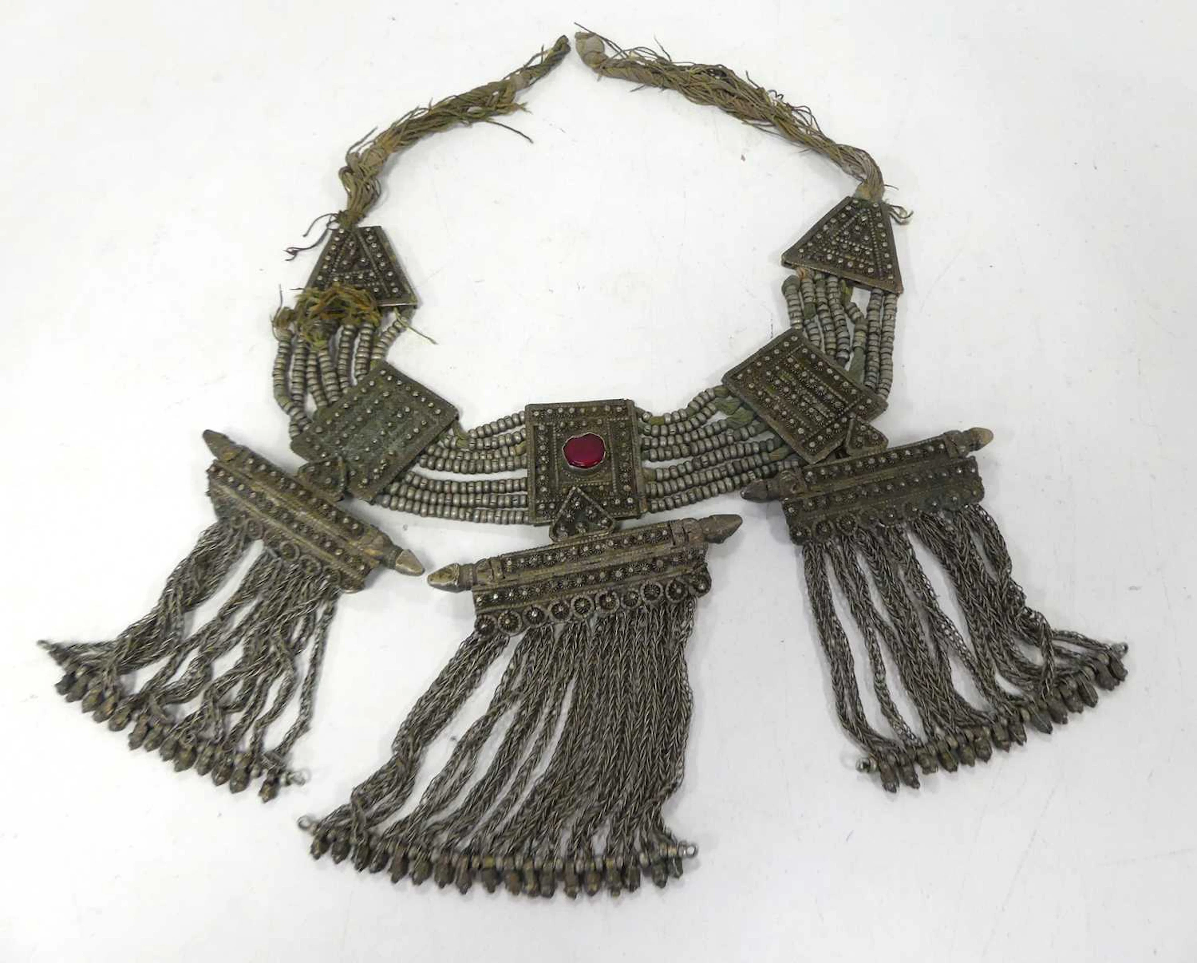 Lot 566 - A Tibetan white metal necklace, the central