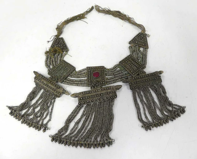 Lot 566 - A Tibetan white metal necklace, the central