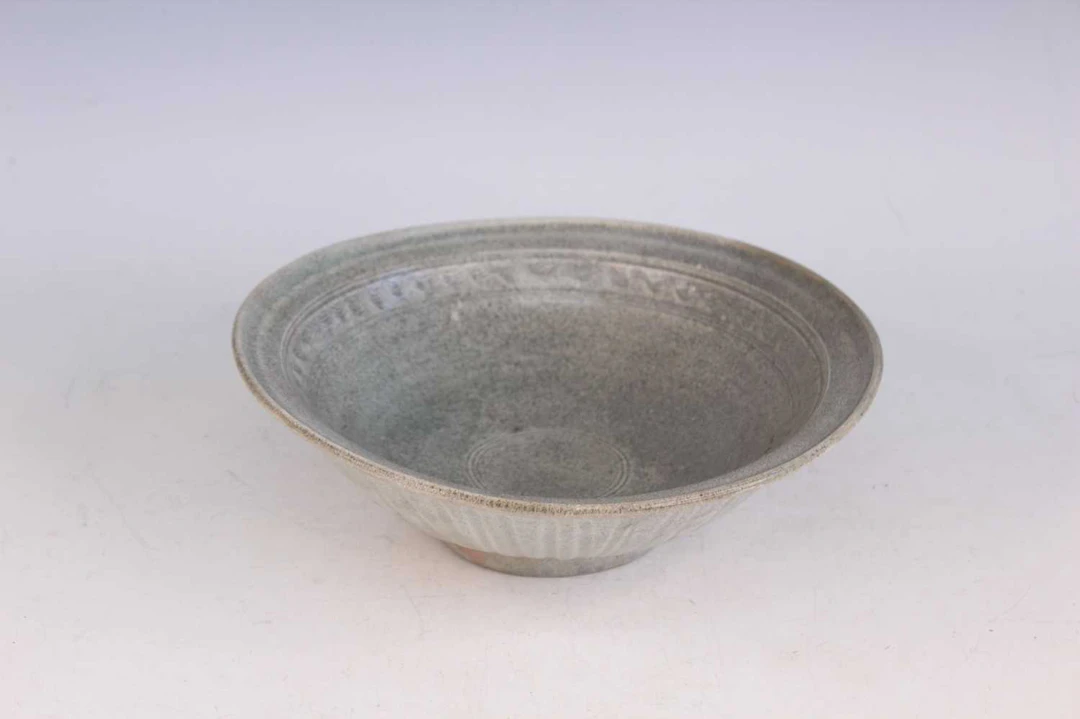 Lot 62 - A large Thai Sawankhalok celadon-glazed bowl