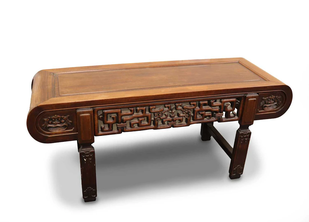 Lot 186 - A Chinese carved hardwood low table with two