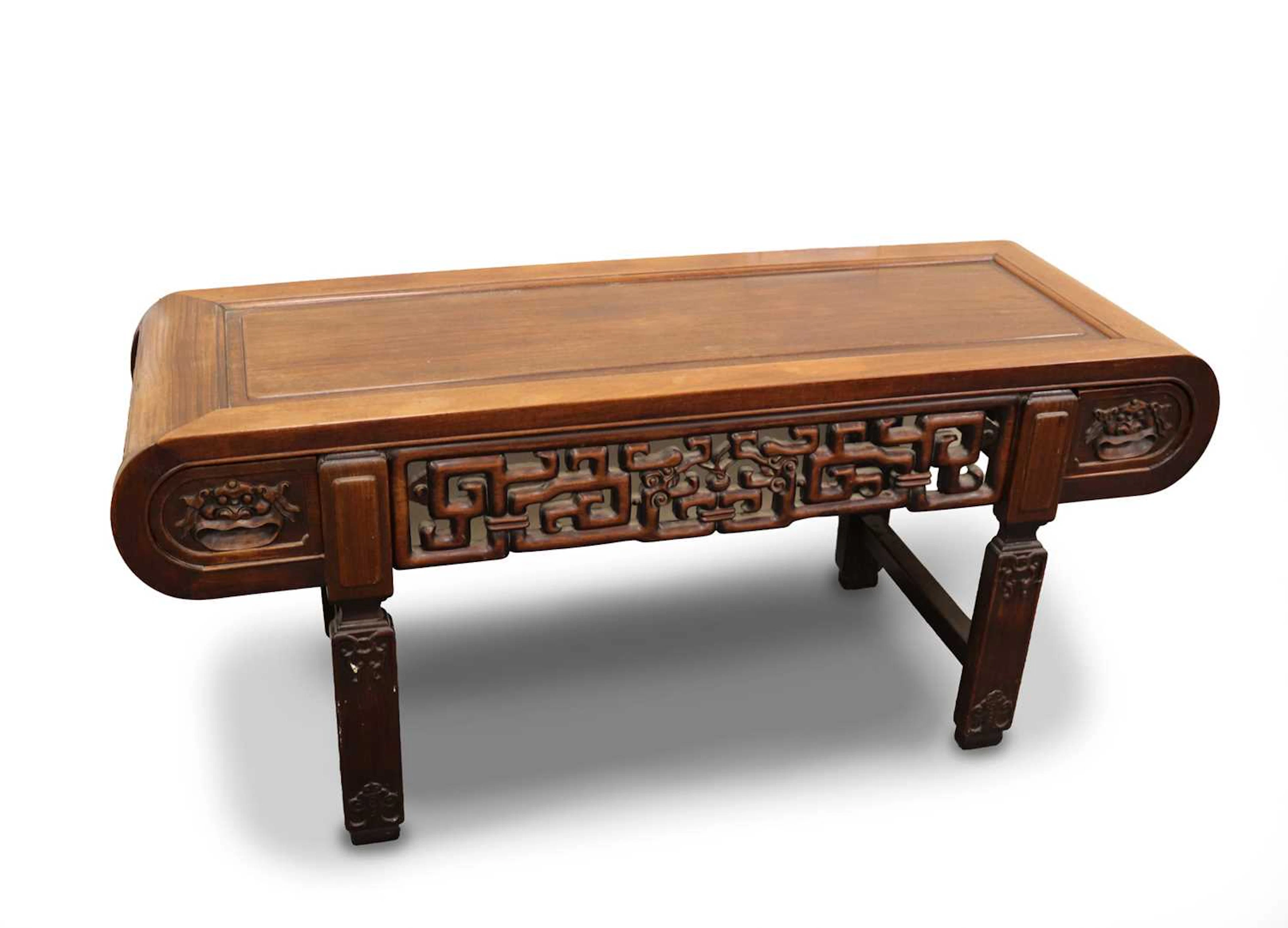 Lot 186 - A Chinese carved hardwood low table with two