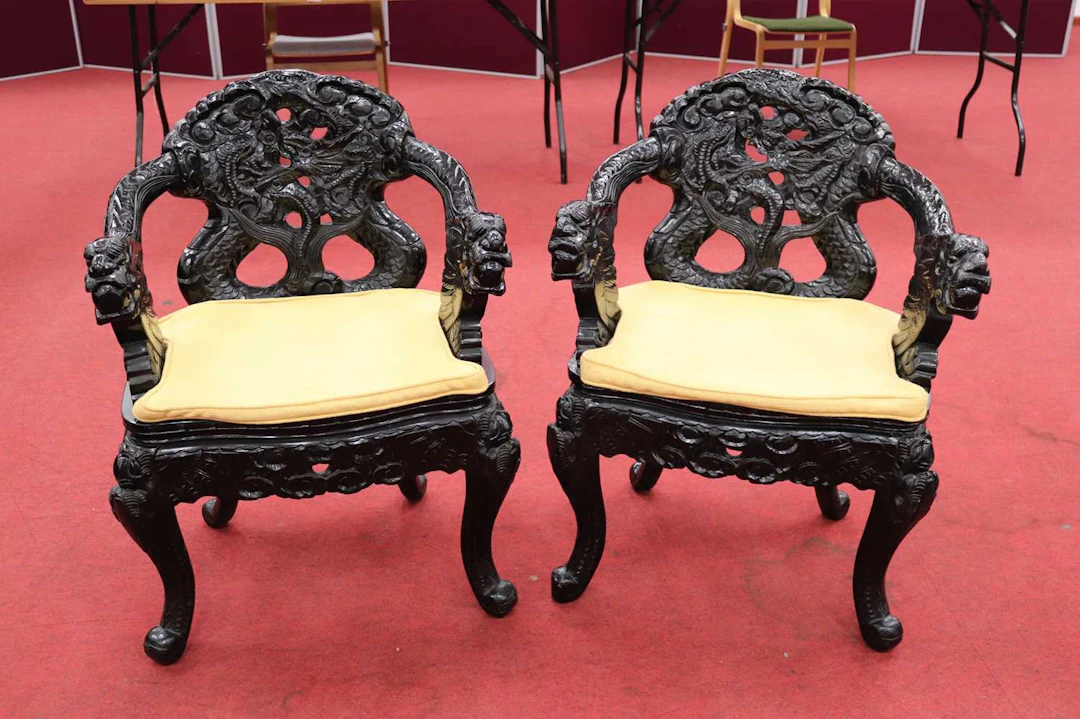 Lot 180 - A pair of Chinese black lacquered carved