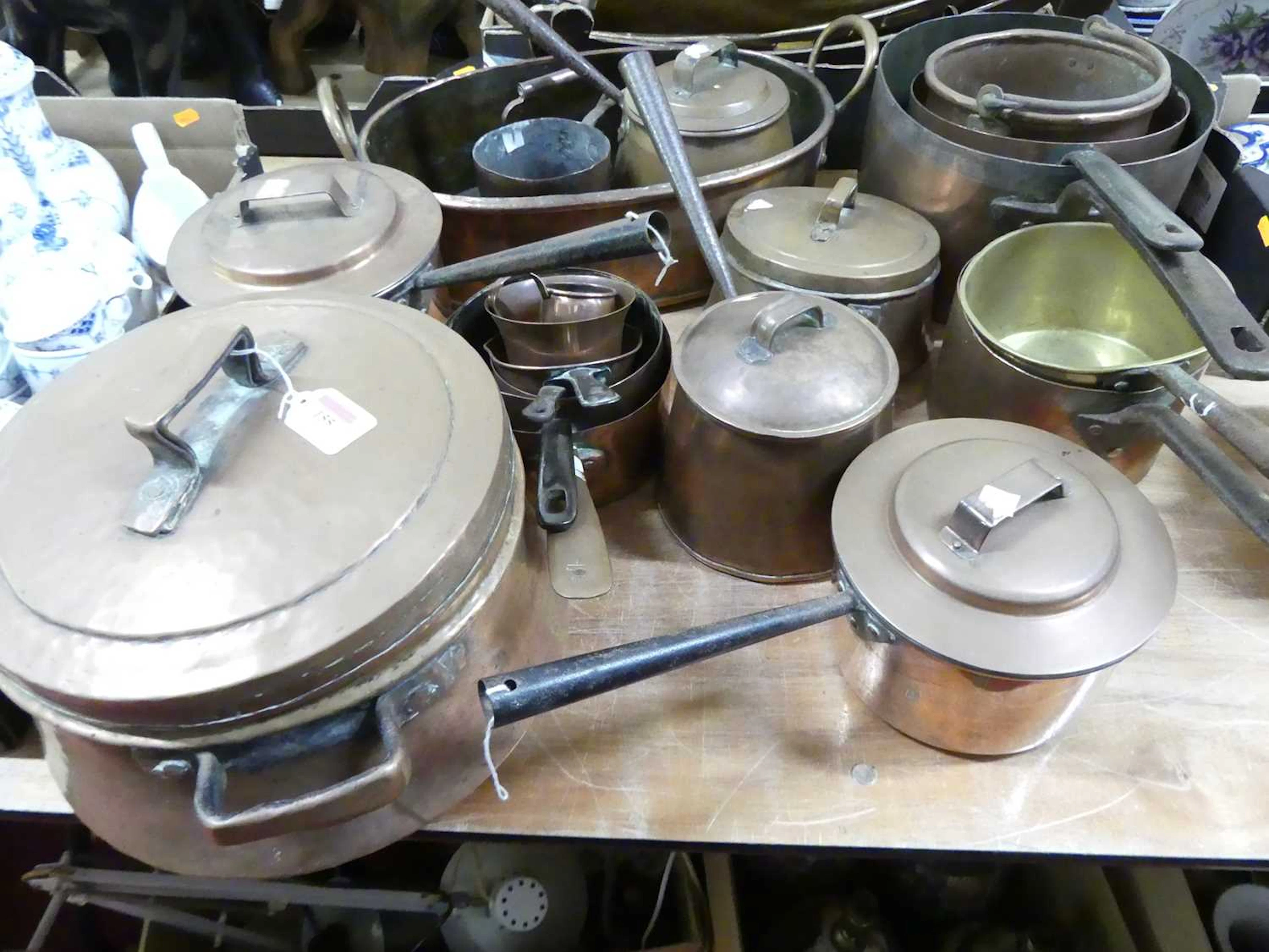 Lot 155 - A collection of copper saucepans and cooking