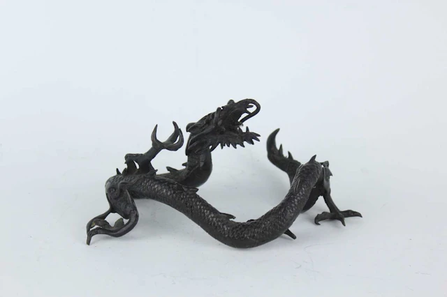 Lot 209 - A Japanese bronze okimono of a dragon, Meiji
