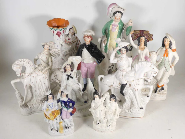 Lot 46 - A collection of Staffordshire pottery figures