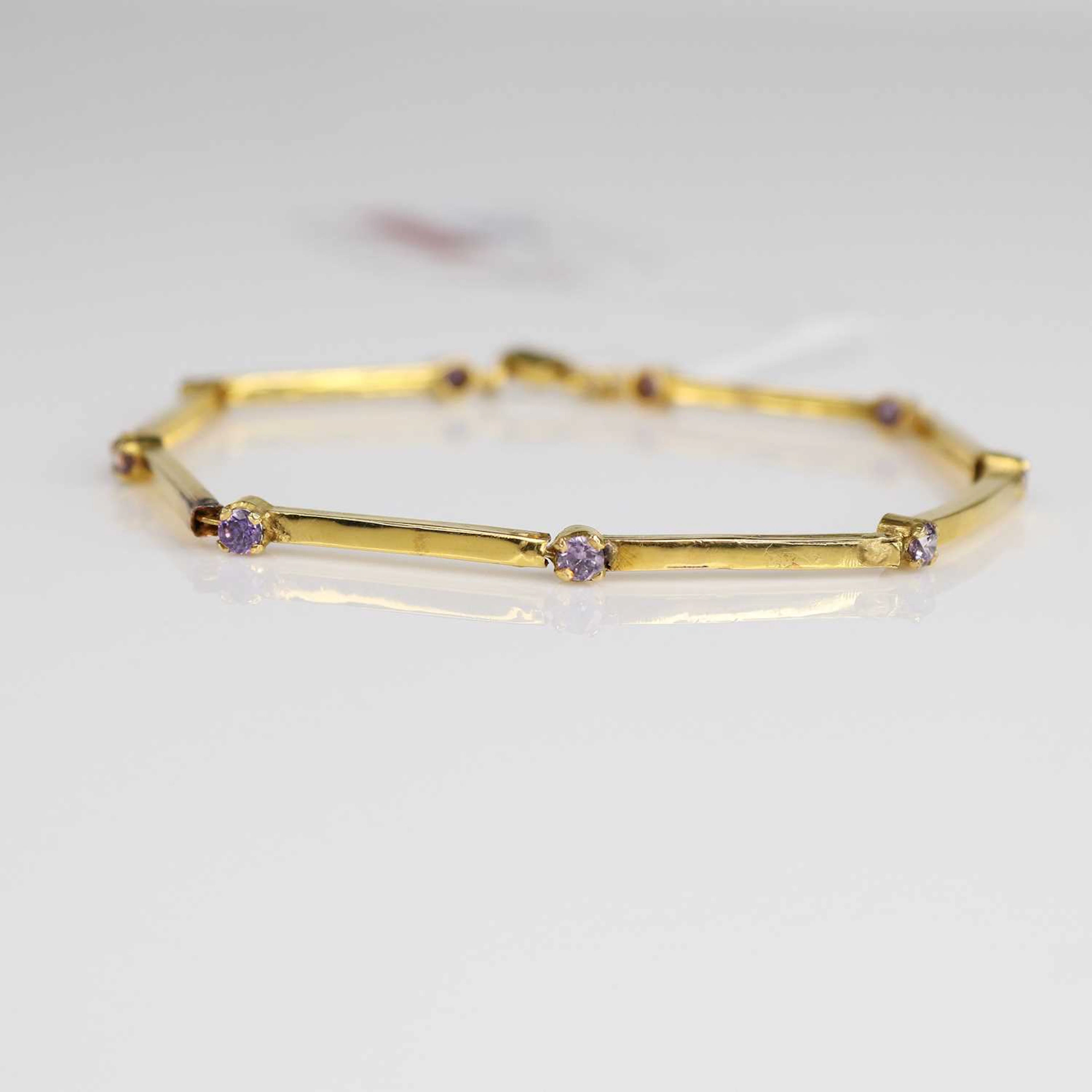 Lot 231 - A yellow metal tanzanite? set bar link